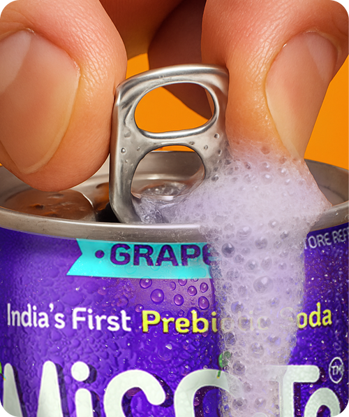 Purple can of 'India's First Prebiotic Soda' being opened with a hand.